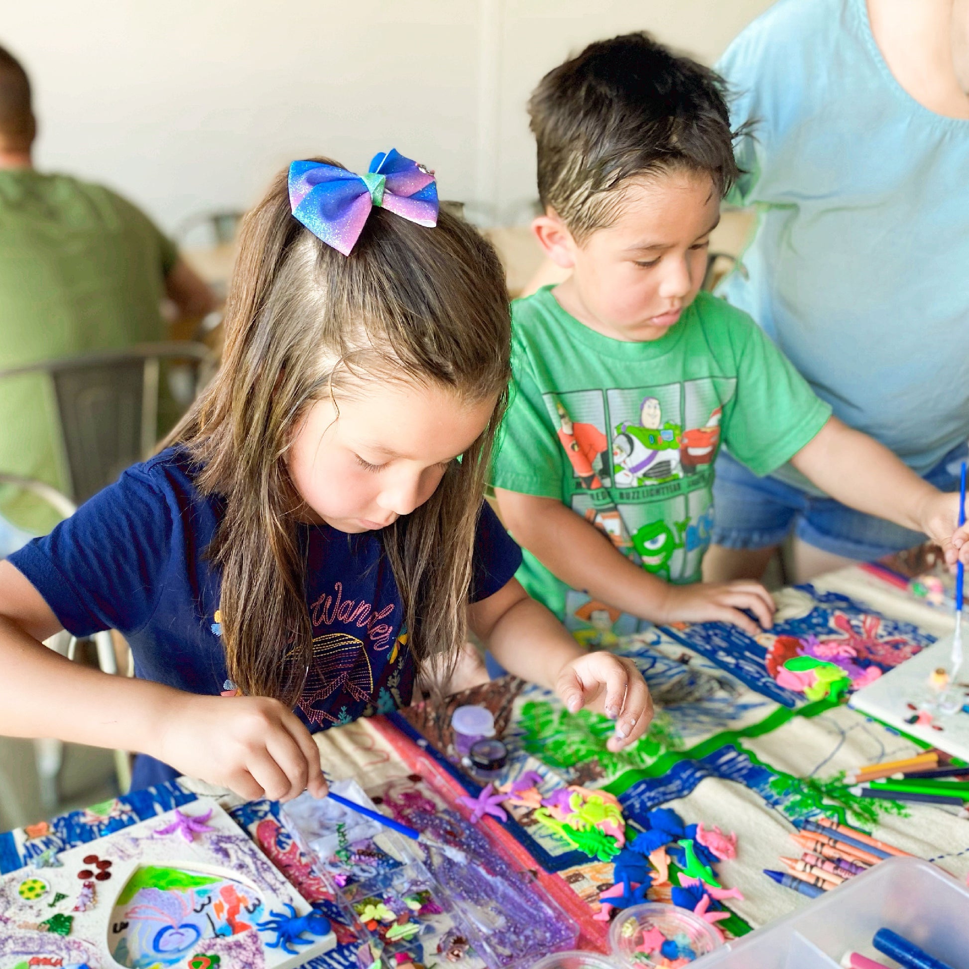 Kids crafting for the Alebrije workshop at the fern la